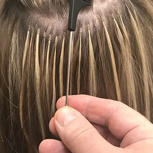 A row of microbeads beside the narrow rod of a tail comb