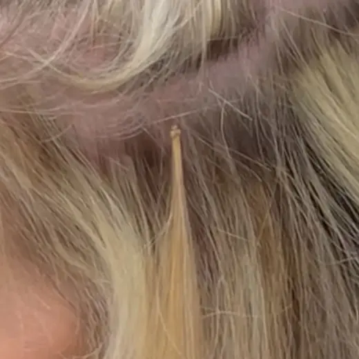 A finished microbead strand lying flat against the head